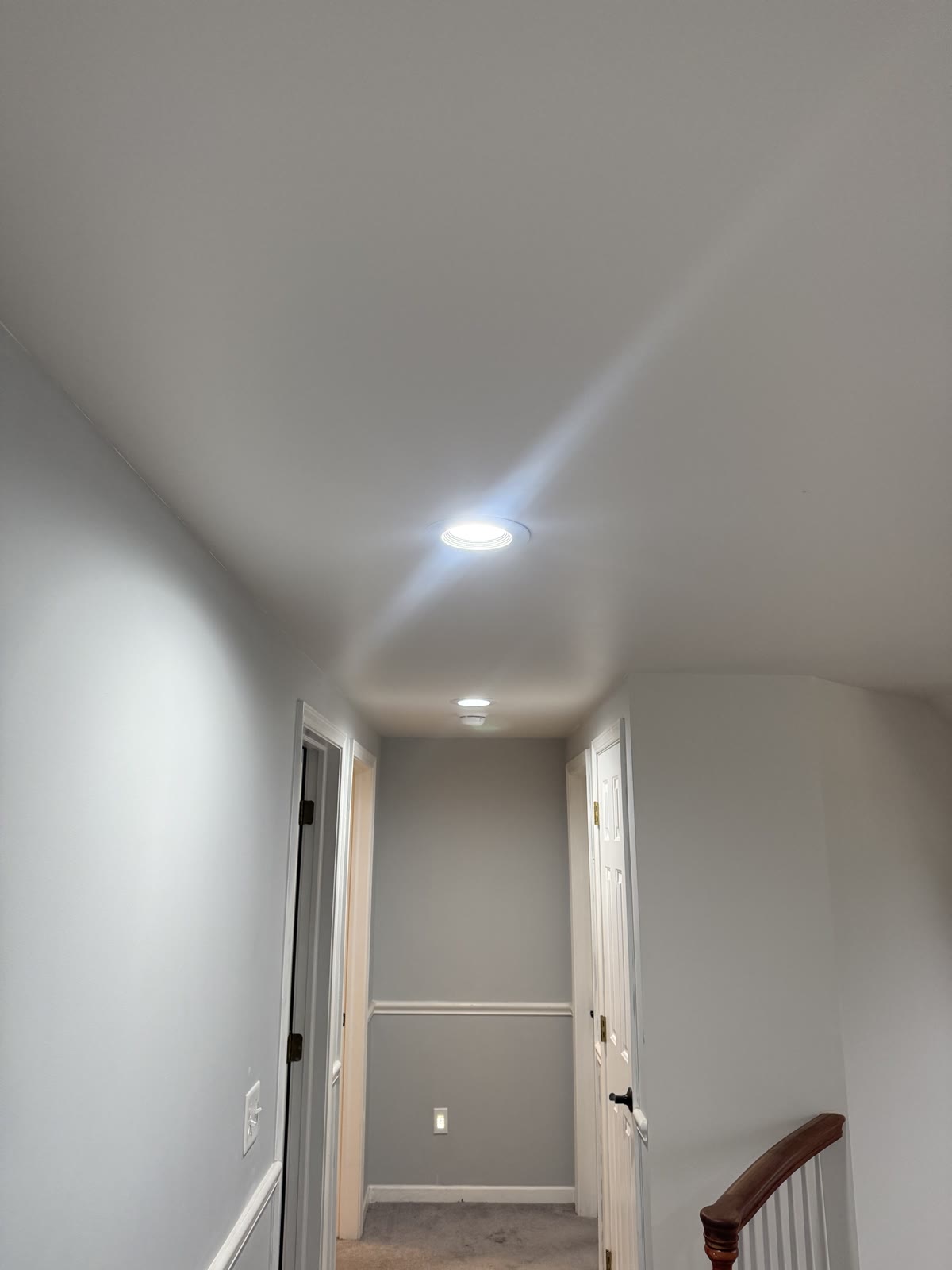 Second-floor hallway ceiling before cutting the attic access opening.