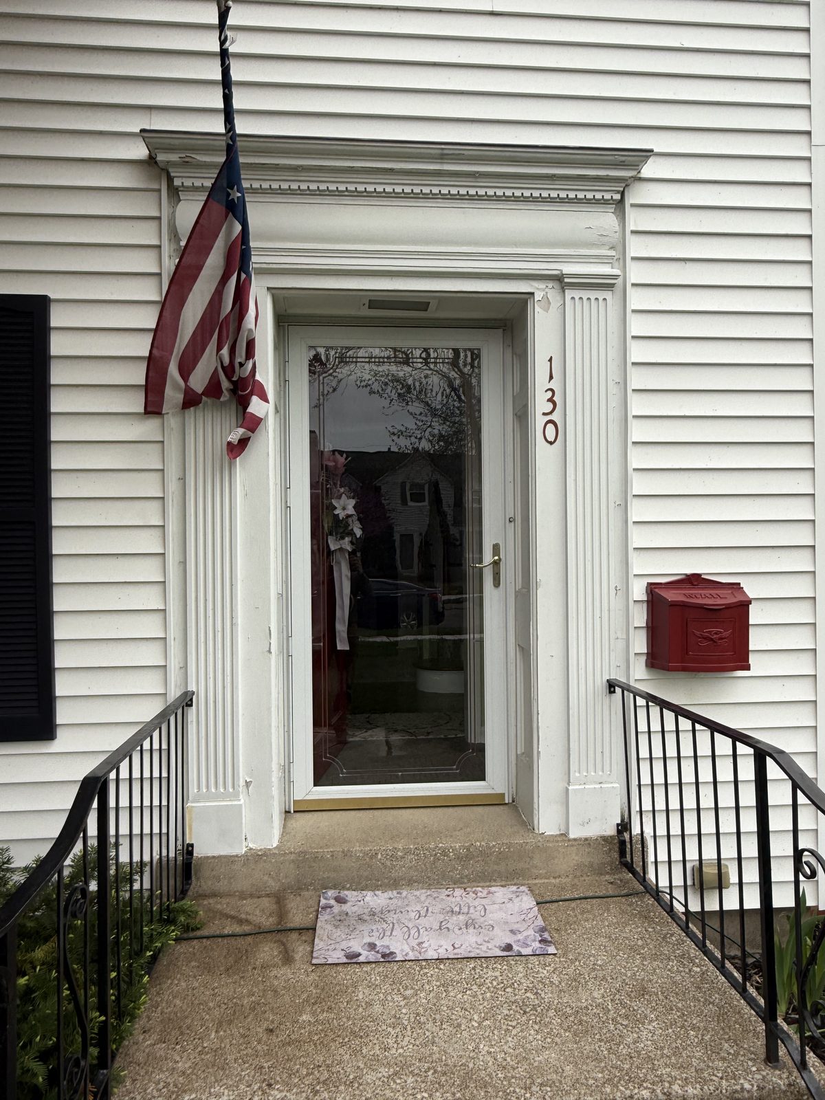 The entry before work began, with weathered paint on the door surround.