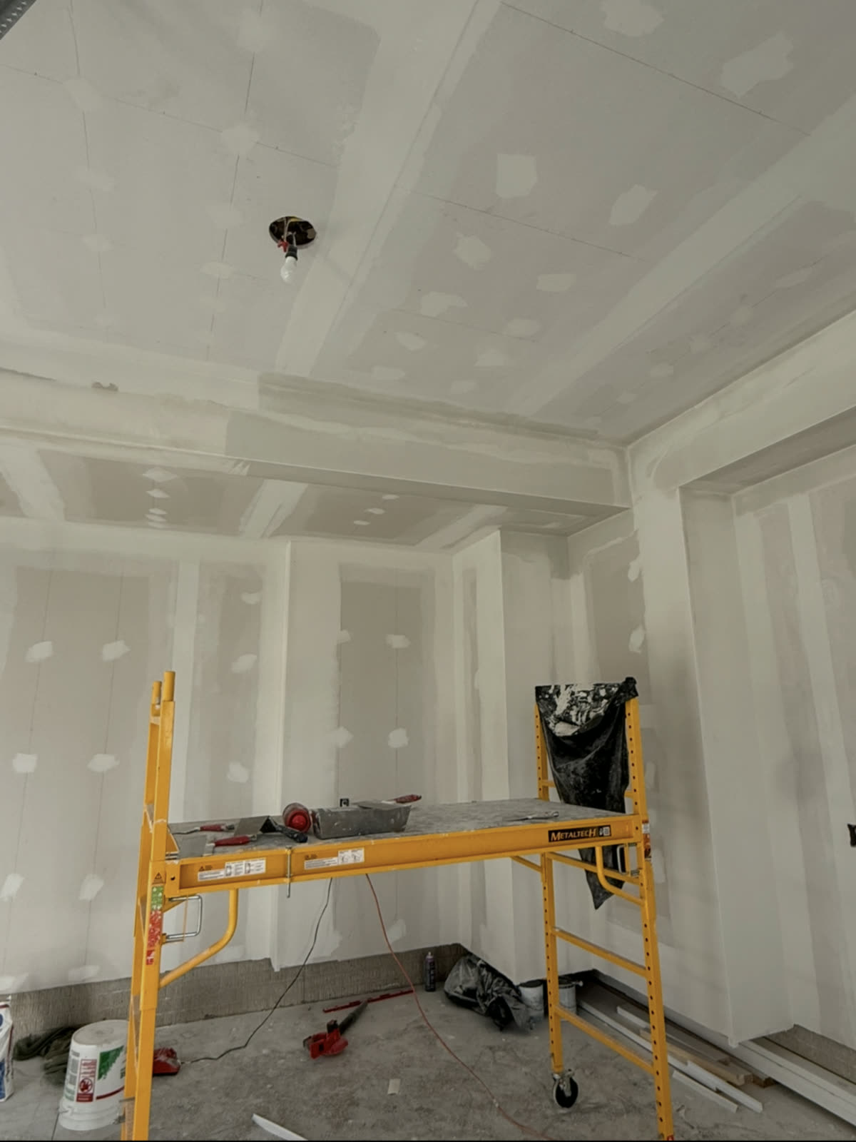 A garage ceiling and walls skim coated and ready for a final coat