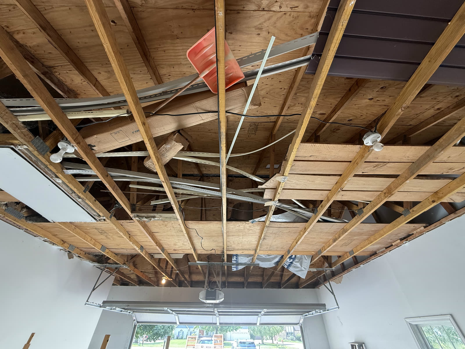 Ceiling stripped back to bare joists, wiring and ductwork exposed.