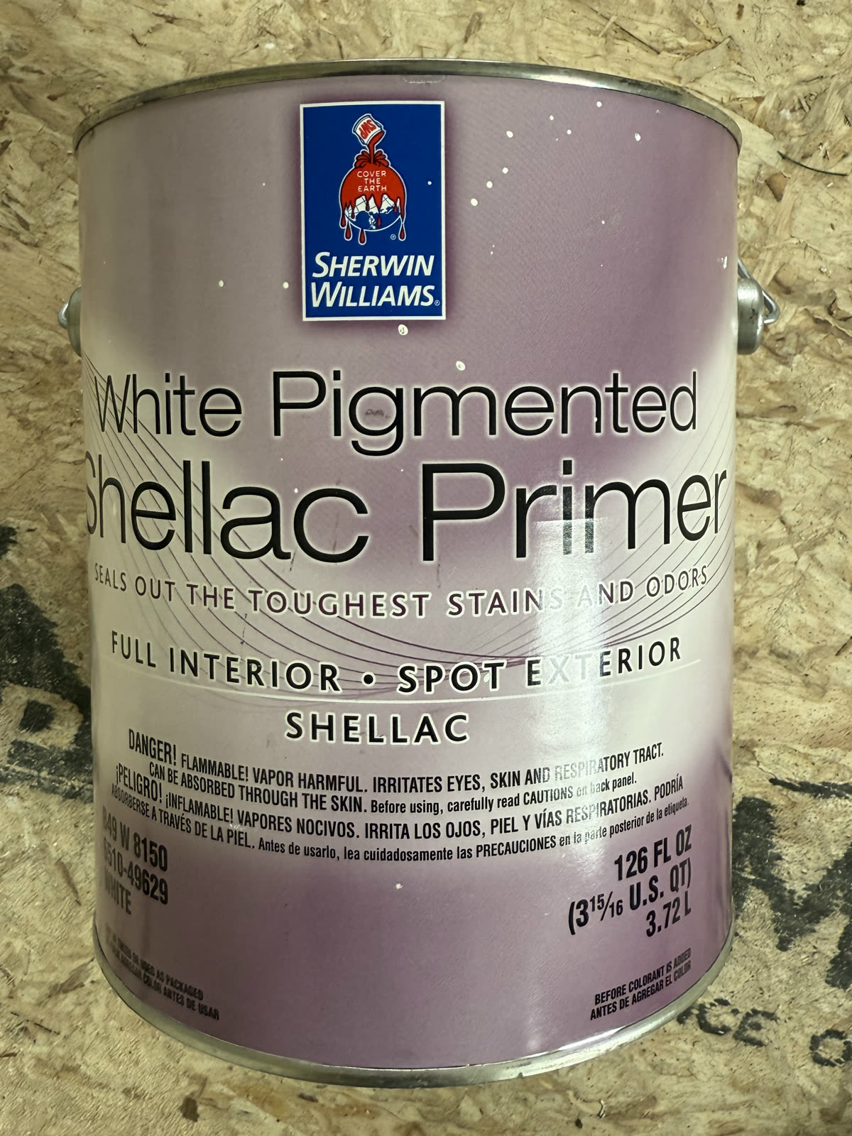 A can of Sherwin Williams White Pigmented Shellac Primer, labeled "Seals Out the Toughest Stains and Odors"