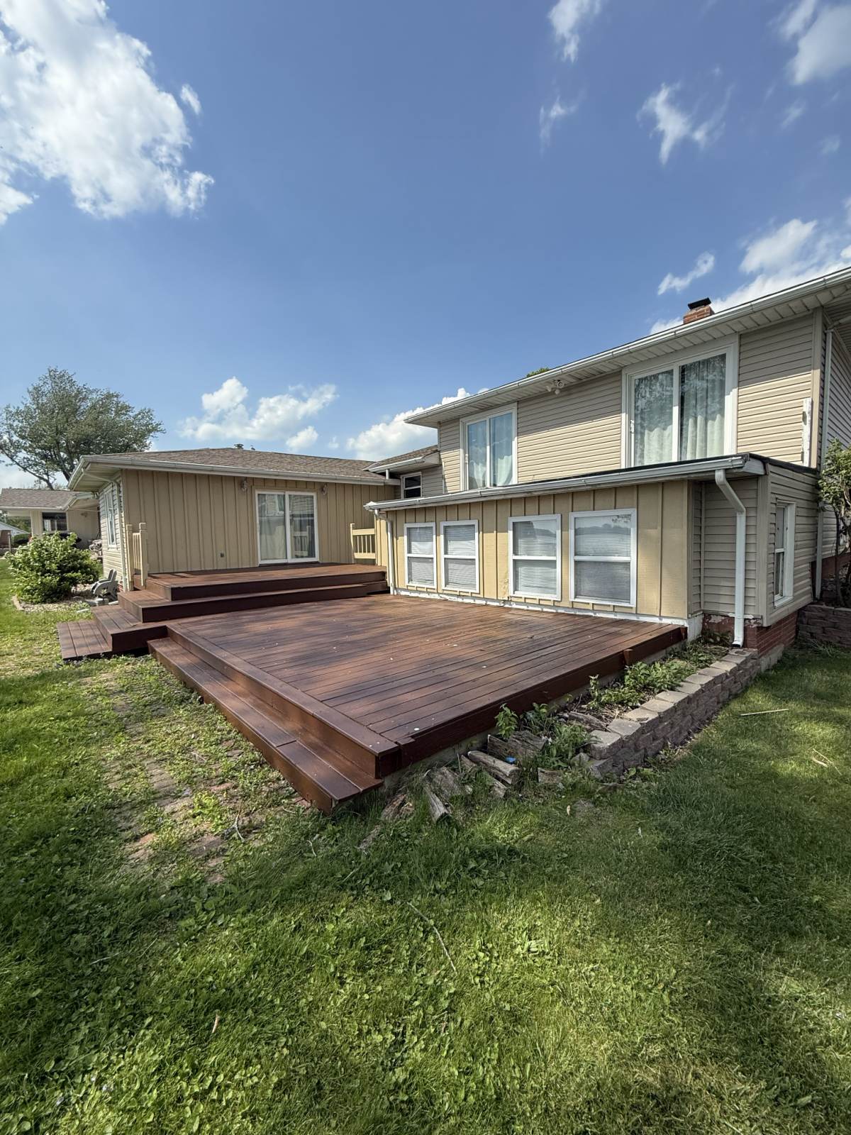 A backyard deck freshly refinished, rich and even from edge to edge