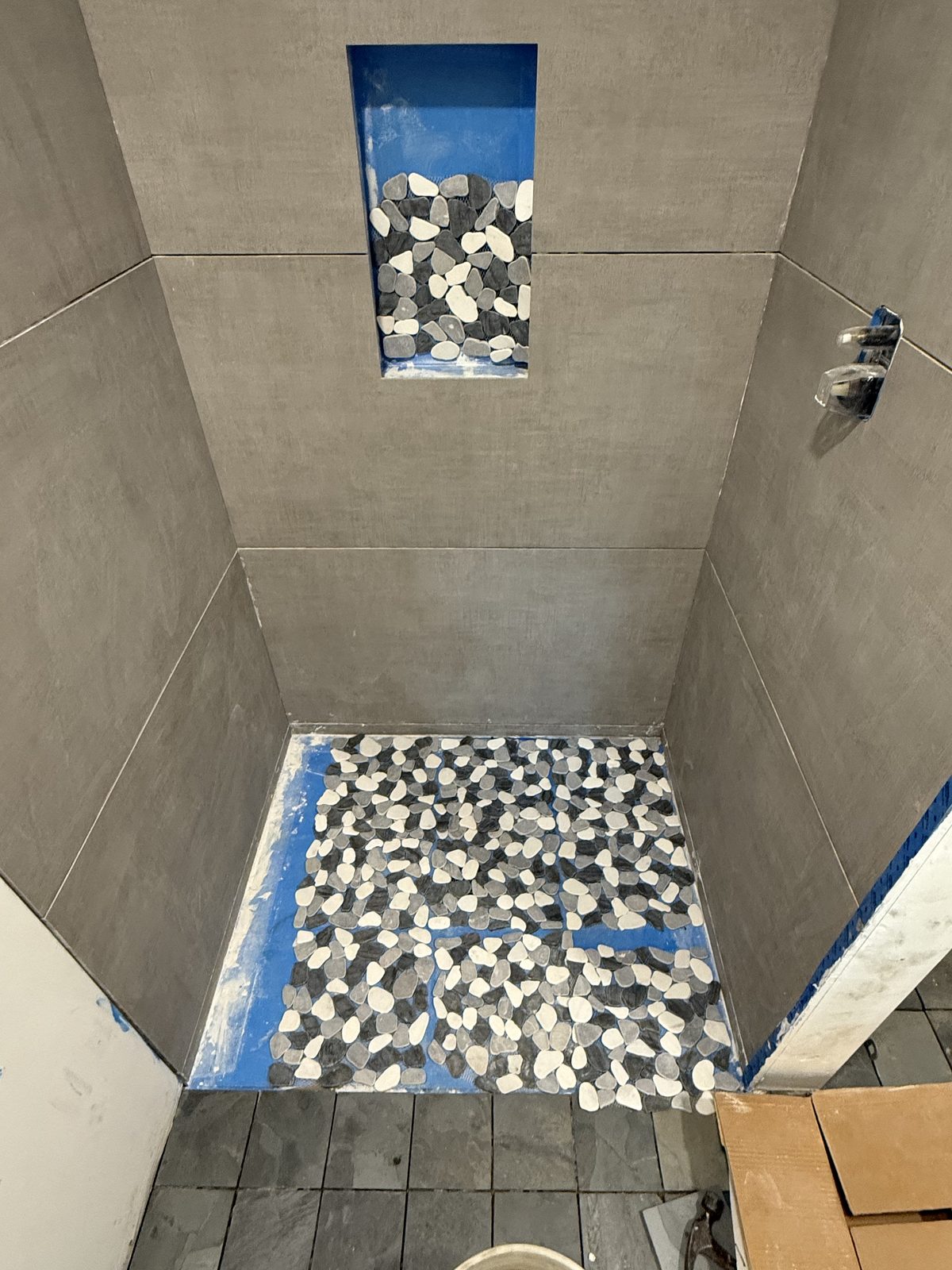 Finished pebble floor and mosaic niche.