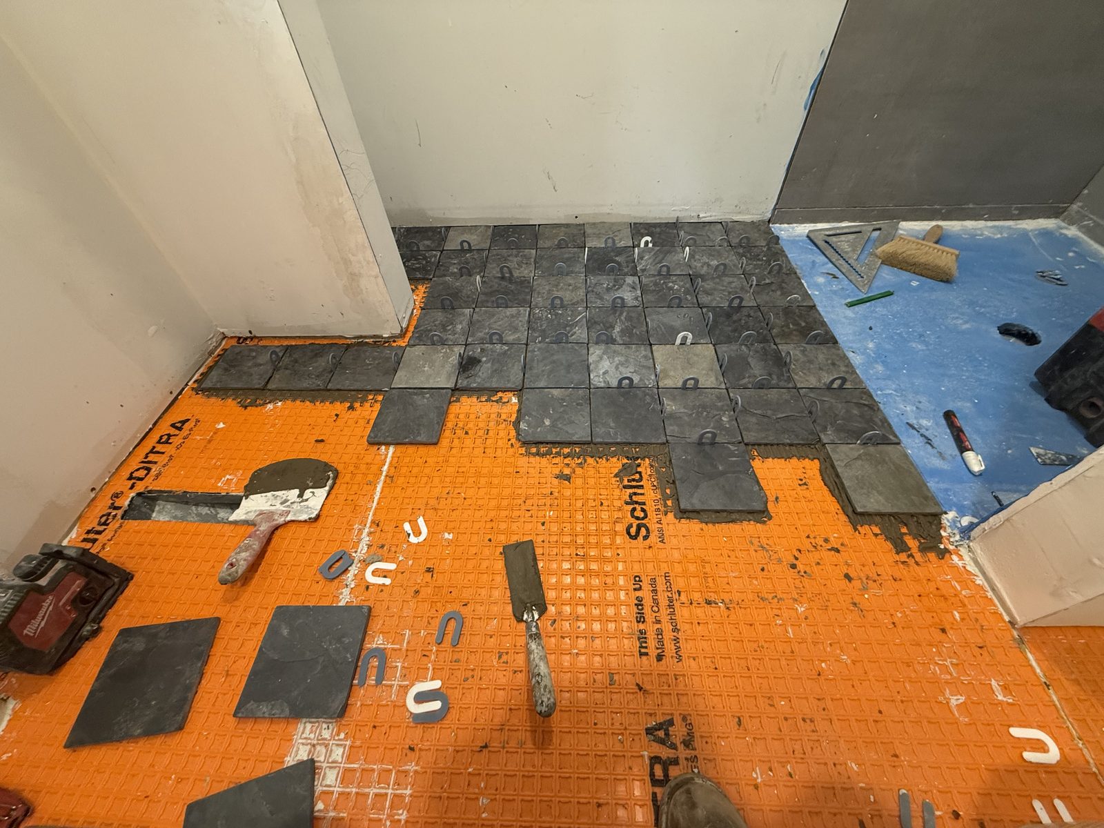 Wall tile being laid out and set.