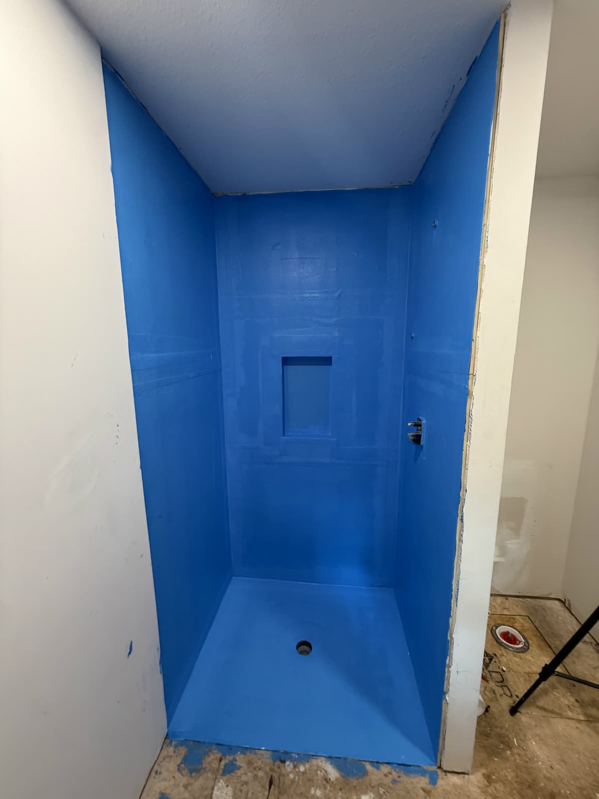 The shower pan, walls and niche fully waterproofed before any tile.